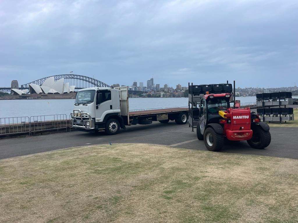 Quick Cargo flat-top truck and forklift at a freight yard