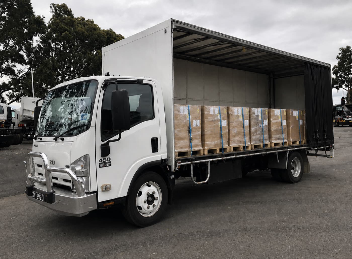 Quick Cargo curtain-side truck opened to show palletised freight loaded inside