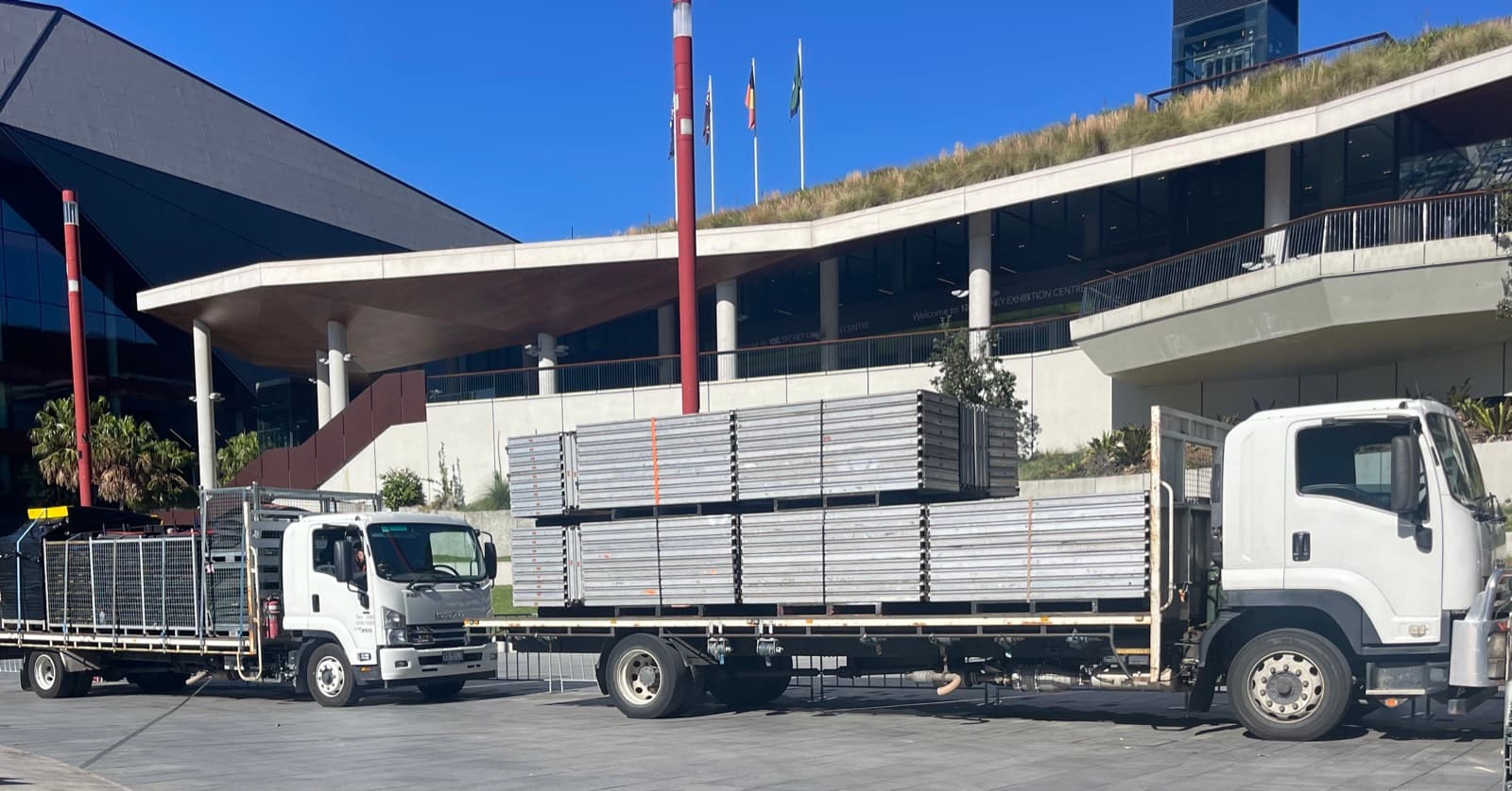 Quick Cargo flatbed trucks on site at a venue for an event bump in