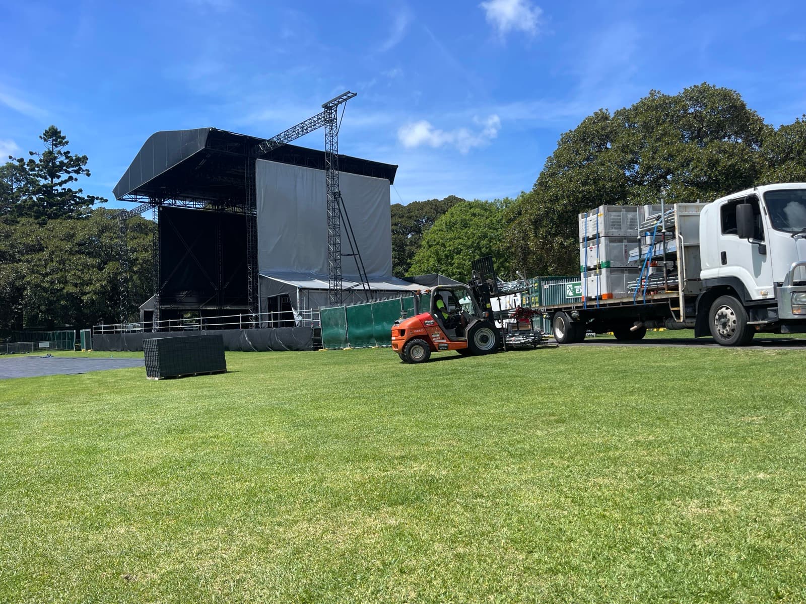 Quick Cargo flatbed unloading staging on site for an outdoor event build