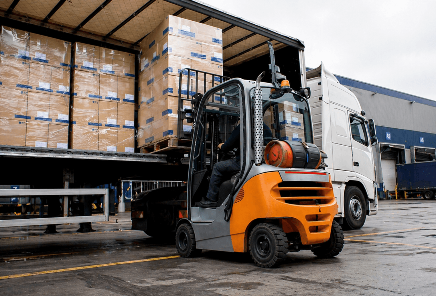 Forklift unloading palletised freight from a semi-trailer