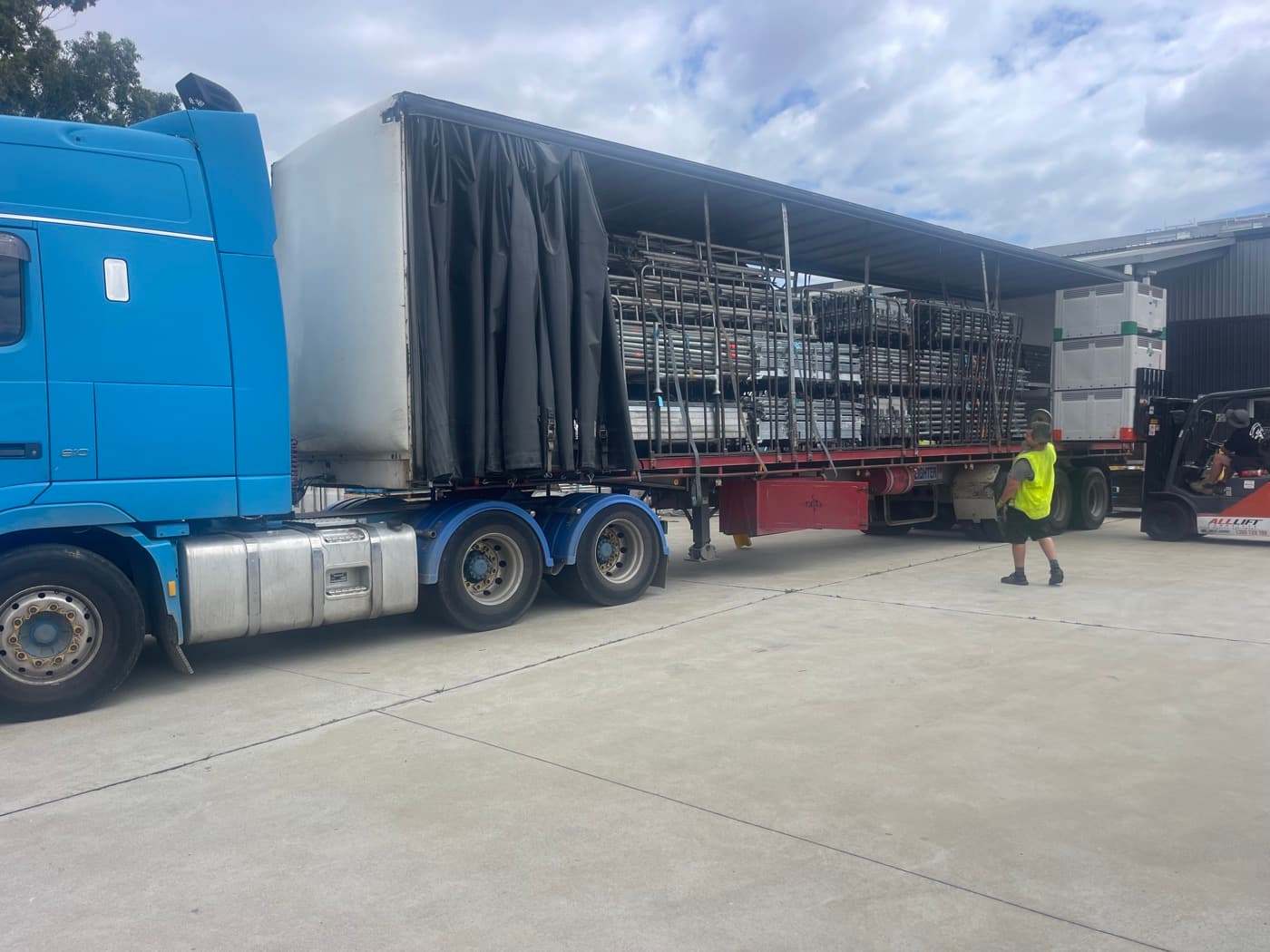 Forklift loading freight into a Quick Cargo curtain-side trailer for interstate linehaul