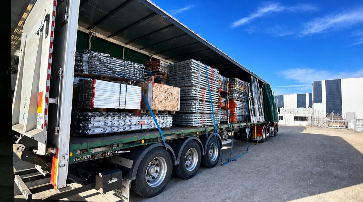 Palletised and racked freight strapped down on a Quick Cargo trailer