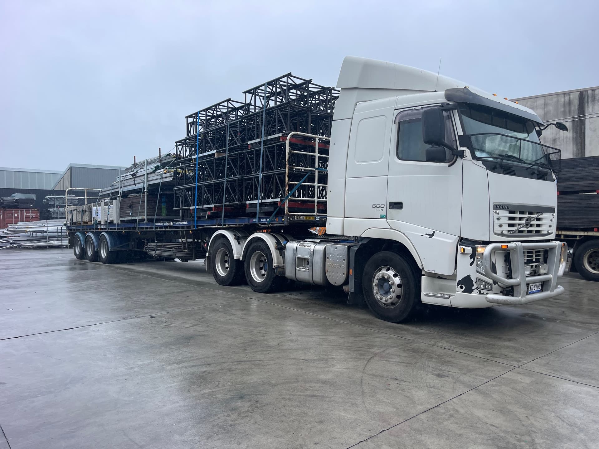 White Volvo prime mover with a loaded trailer ready for delivery